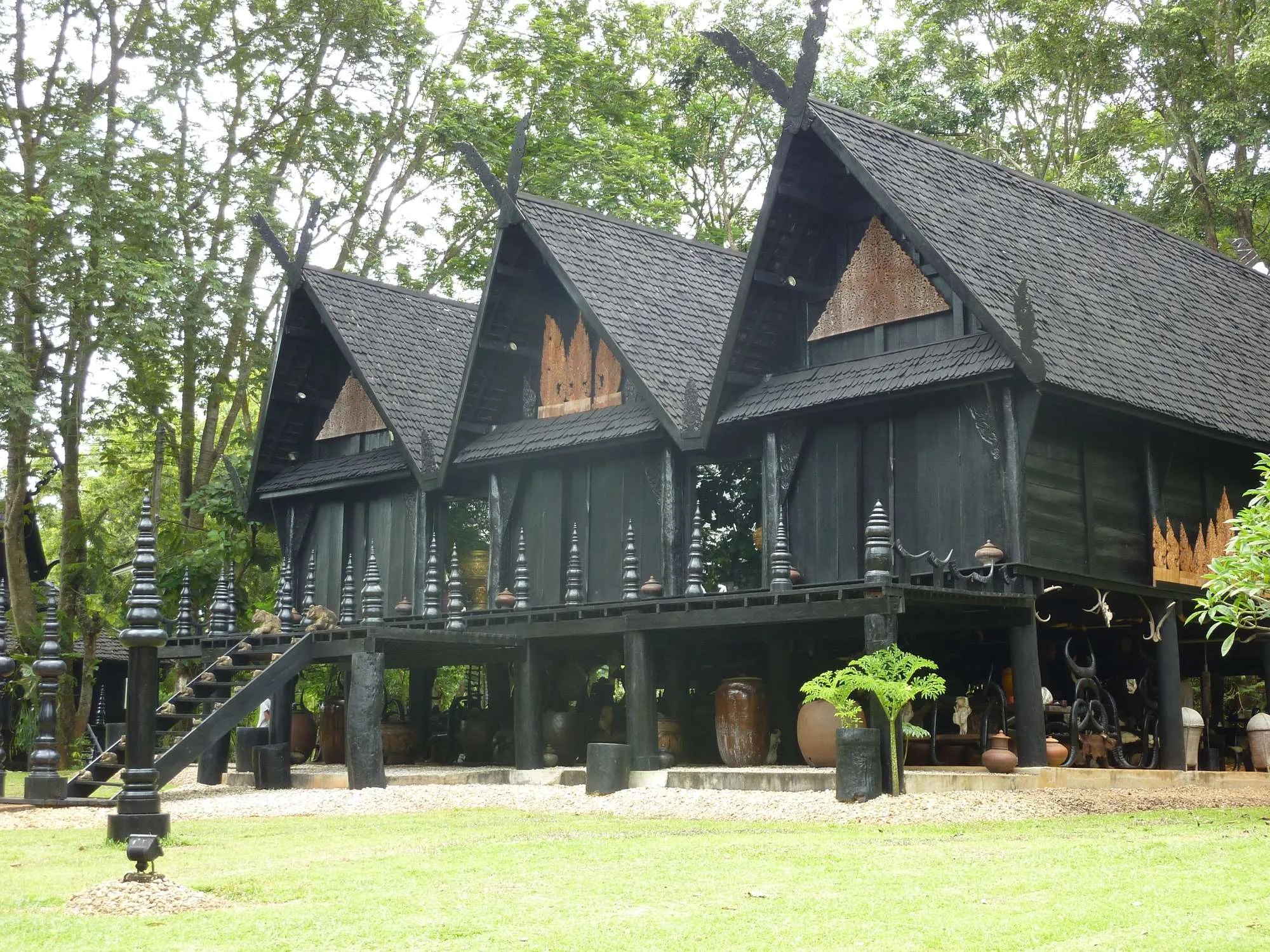 The dark teak buildings of the Baan Dam Museum