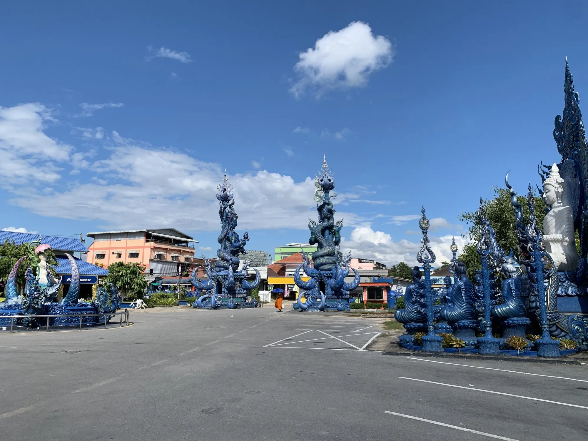The vivid blue and gold interior of Wat Rong Suea Ten