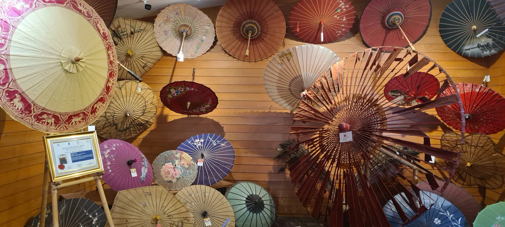Rows of brightly painted paper umbrellas drying in Bo Sang