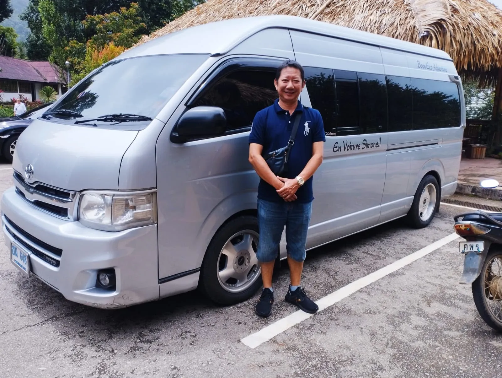 Boon standing next to his silver Toyota minivan