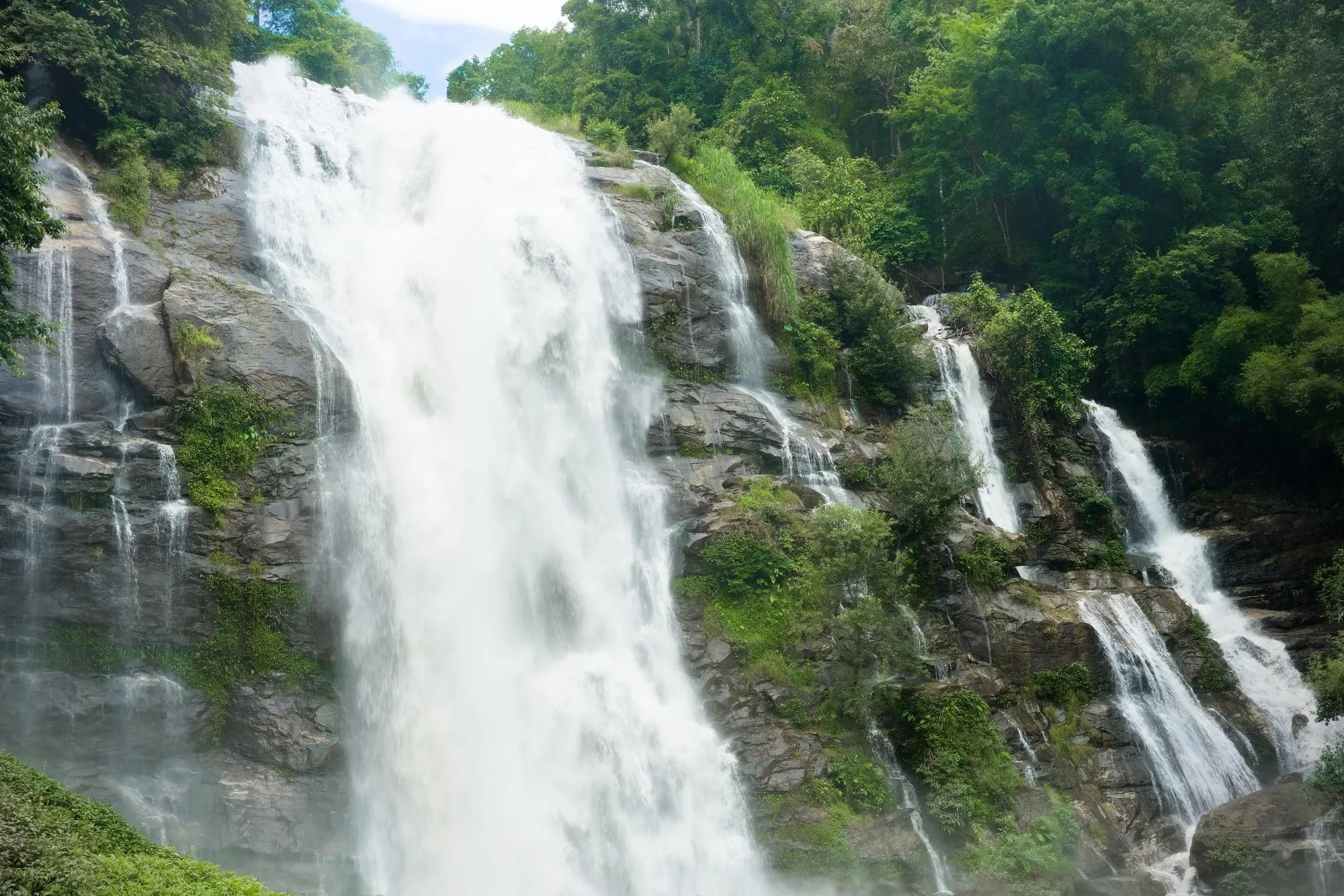 Wachirathan waterfall crashing over dark rocks